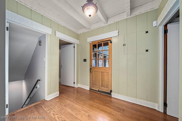 interior space featuring beamed ceiling and light hardwood / wood-style floors