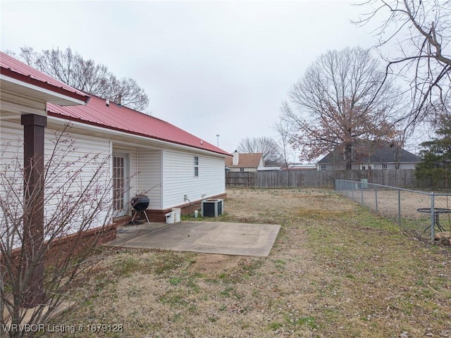 view of yard with a fenced backyard, cooling unit, and a patio