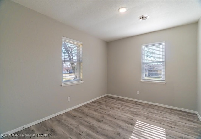 unfurnished room featuring light hardwood / wood-style flooring