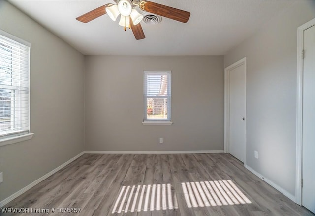 spare room with light hardwood / wood-style floors and ceiling fan