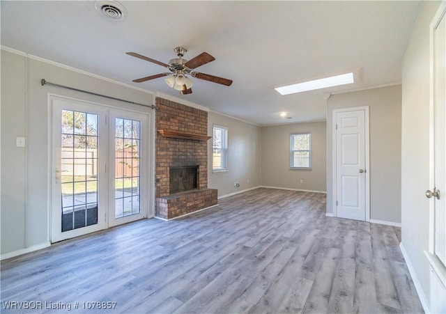 unfurnished living room featuring crown molding, light wood-type flooring, and a fireplace