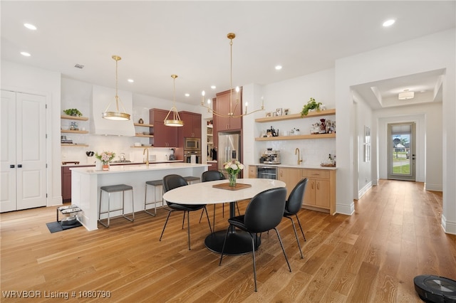 9101 Birkshire Pl, Fort Smith, AR 72916 - dining space with visible vents, light wood-style flooring, indoor wet bar, and recessed lighting