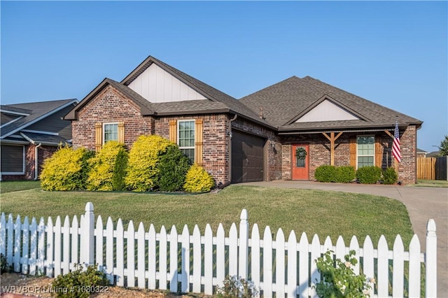 view of front of property featuring a fenced front yard, concrete driveway, an attached garage, brick siding, and a front yard