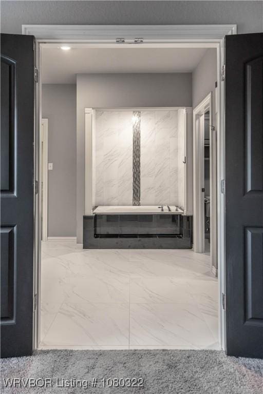 hall with marble finish floor