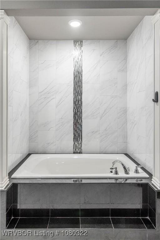 bathroom with tiled tub and recessed lighting