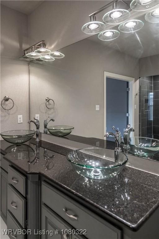 full bathroom featuring double vanity and a sink