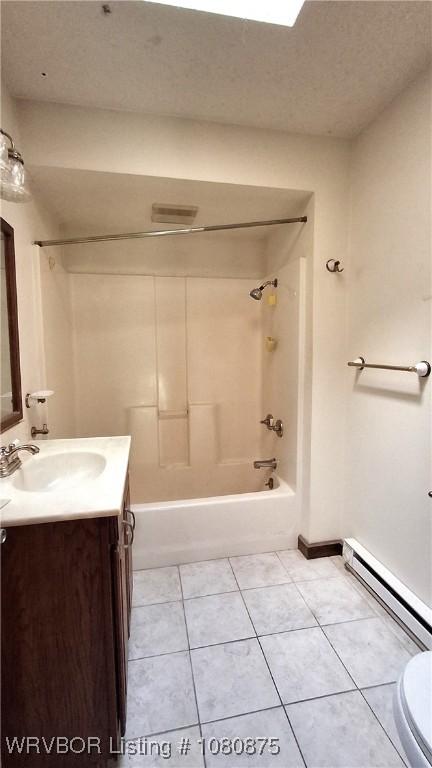 full bath with shower / bath combination, vanity, a baseboard radiator, tile patterned flooring, and toilet