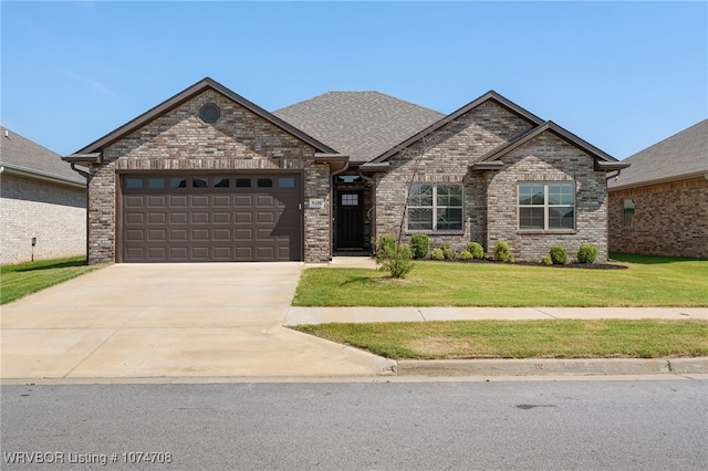 view of front of house with a garage and a front lawn