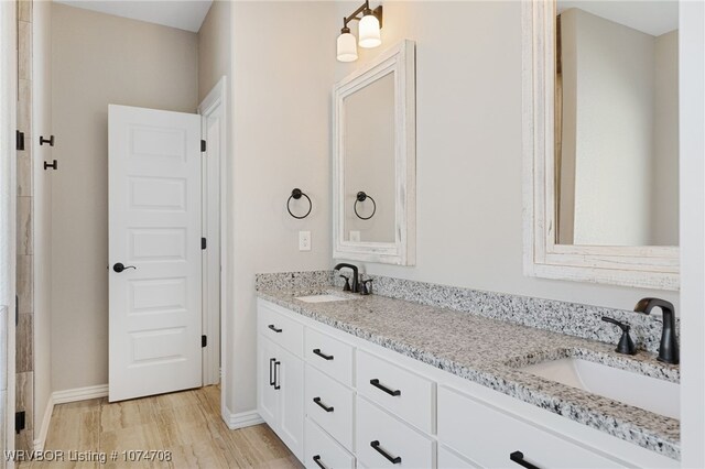 bathroom with vanity and wood-type flooring