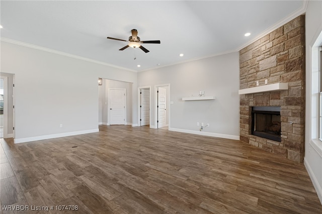 unfurnished living room featuring ceiling fan, a stone fireplace, wood-type flooring, and crown molding