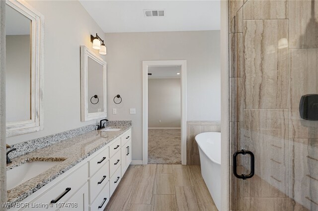 bathroom featuring vanity and shower with separate bathtub