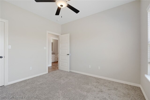 empty room with ceiling fan and carpet floors