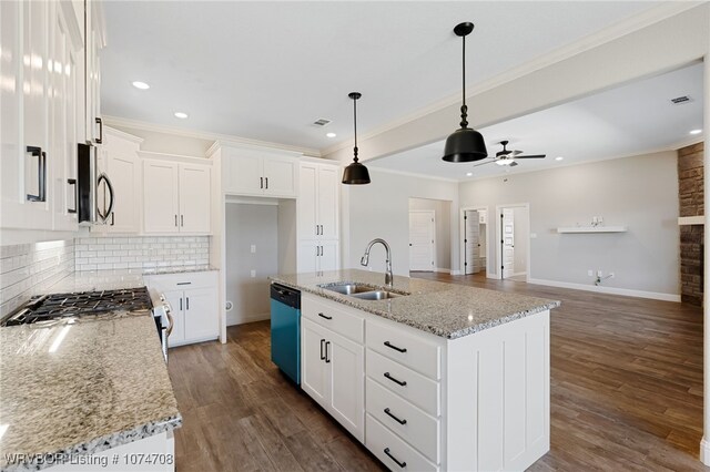 kitchen featuring sink, white cabinetry, a kitchen island with sink, and appliances with stainless steel finishes