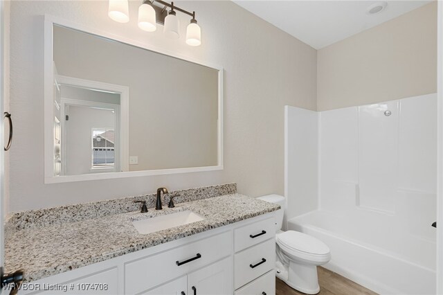 full bathroom with shower / bathing tub combination, vanity, toilet, and wood-type flooring