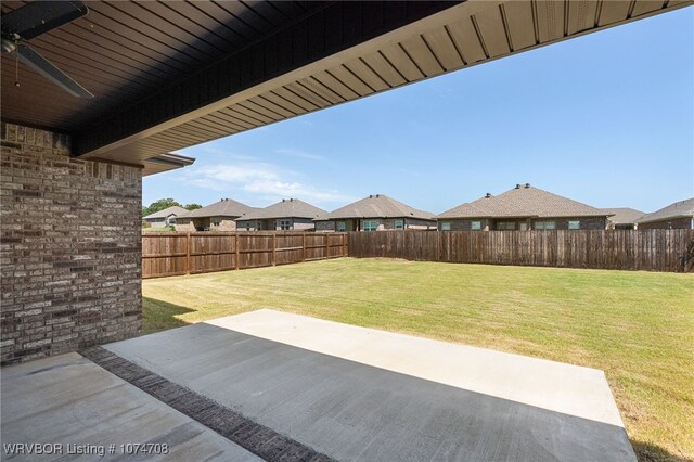 view of yard featuring a patio and ceiling fan