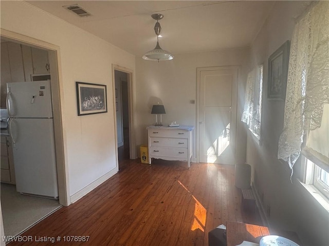 interior space with white refrigerator and dark wood-type flooring