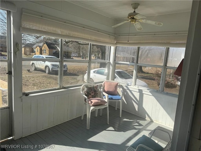 sunroom / solarium featuring ceiling fan