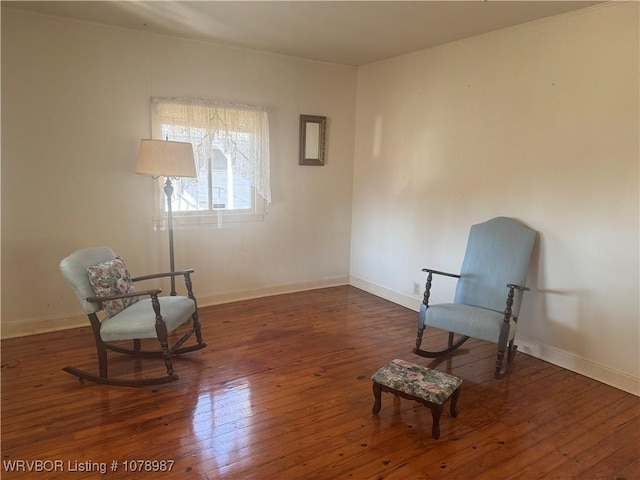 sitting room with dark wood-type flooring