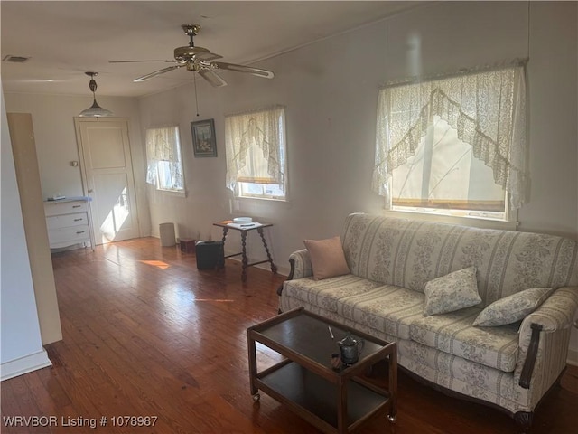 living room featuring ceiling fan and dark hardwood / wood-style flooring