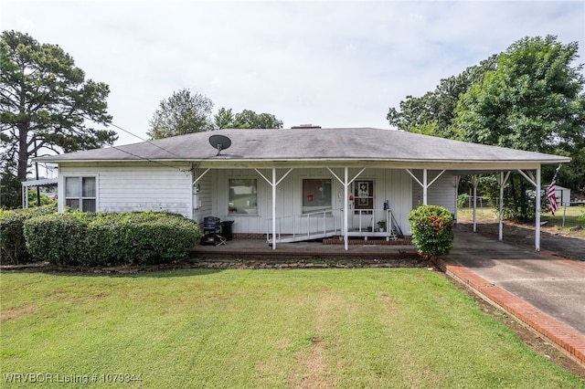 view of front of house featuring a porch, a front yard, board and batten siding, and aphalt driveway