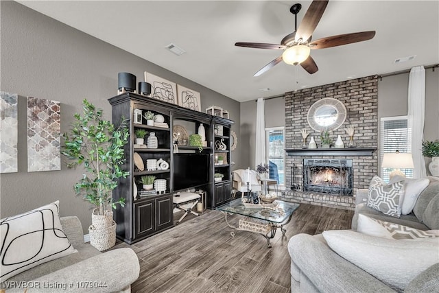 2601 Bugscuffle Rd, Lavaca, AR 72941 - living area featuring ceiling fan, wood finished floors, a fireplace, and a textured wall