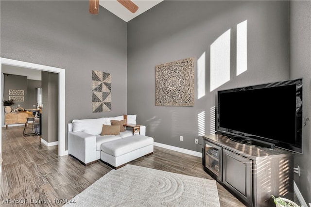 2601 Bugscuffle Rd, Lavaca, AR 72941 - living area featuring a towering ceiling, wood finished floors, and a ceiling fan