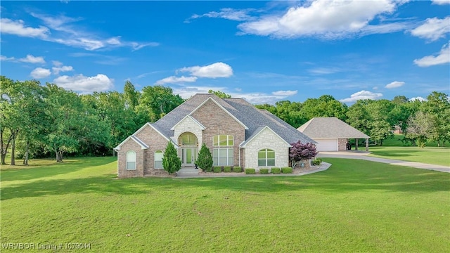 2601 Bugscuffle Rd, Lavaca, AR 72941 - view of front of house featuring a front lawn, stone siding, a garage, and a carport