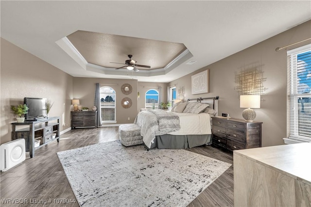 2601 Bugscuffle Rd, Lavaca, AR 72941 - bedroom featuring a tray ceiling, dark wood-style flooring, access to exterior, and ceiling fan