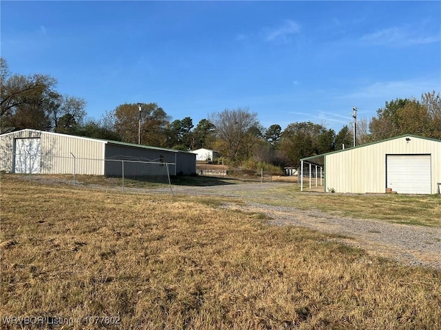 view of yard featuring a garage and an outdoor structure