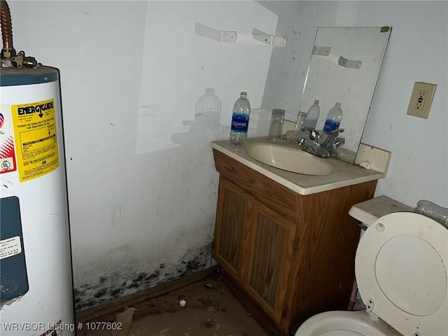 bathroom with electric water heater, vanity, and toilet