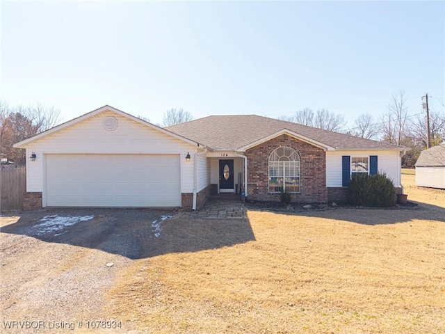 ranch-style home featuring driveway, an attached garage, a shingled roof, and brick siding