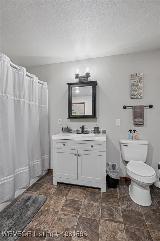 11667 Falling Rock Rd, Havana, AR 72842 - bathroom with vanity, a textured ceiling, and a shower with curtain