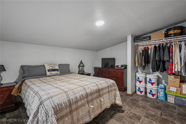 11667 Falling Rock Rd, Havana, AR 72842 - bedroom featuring lofted ceiling and dark stone finish floors