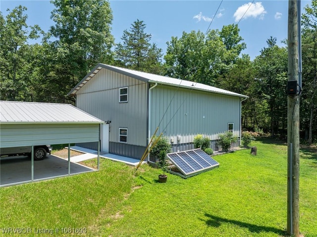 11667 Falling Rock Rd, Havana, AR 72842 - view of home's exterior featuring ground mounted solar panels and a lawn