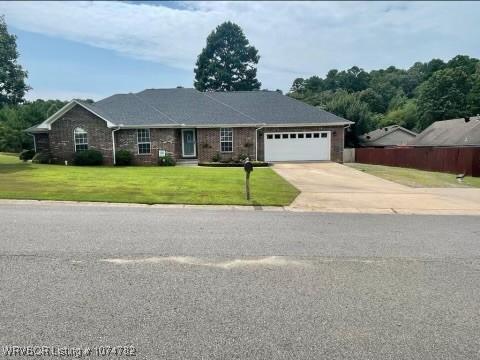 single story home with a front lawn and a garage