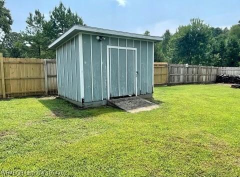 view of outdoor structure featuring a lawn