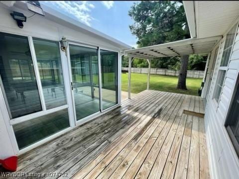 wooden terrace with a lawn