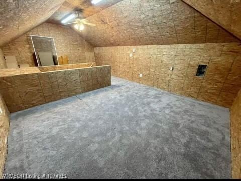 bonus room with ceiling fan and lofted ceiling