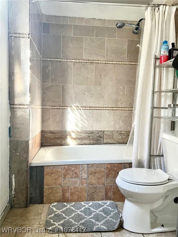 bathroom with toilet and shower / bath combo with shower curtain