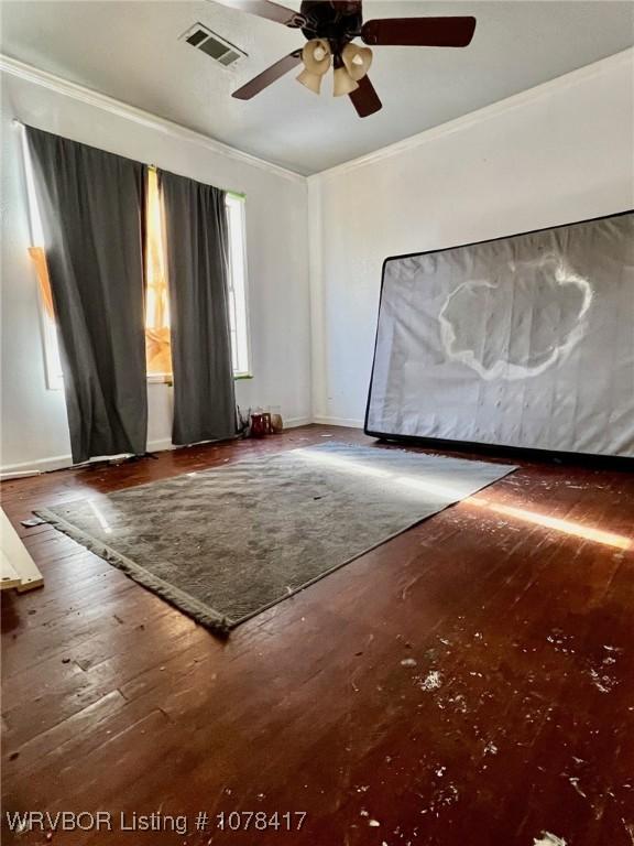 spare room with ceiling fan, dark hardwood / wood-style floors, and crown molding