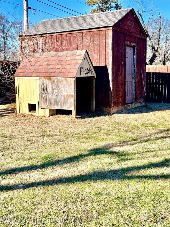 view of outbuilding featuring a lawn