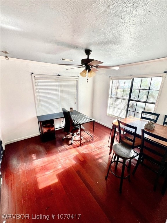 dining area featuring ceiling fan, a textured ceiling, and dark hardwood / wood-style floors