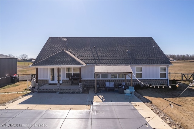 back of house with a porch and a patio area