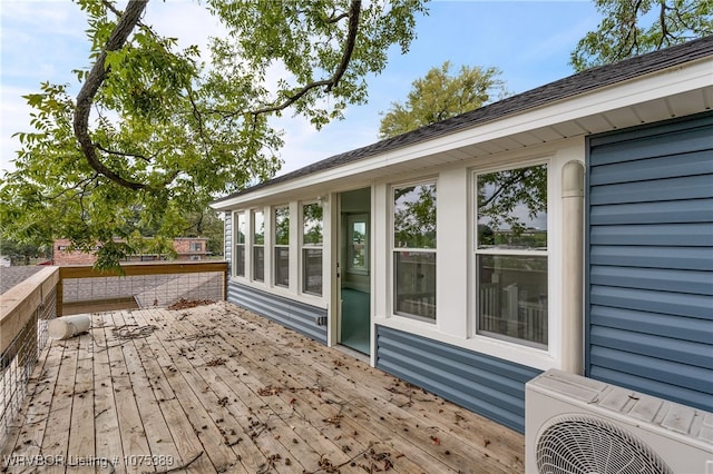 wooden deck featuring ac unit