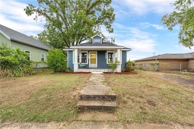 view of front of home featuring covered porch and a front lawn