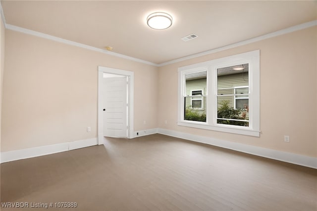 spare room featuring wood-type flooring and ornamental molding