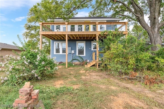 back of property with a wooden deck