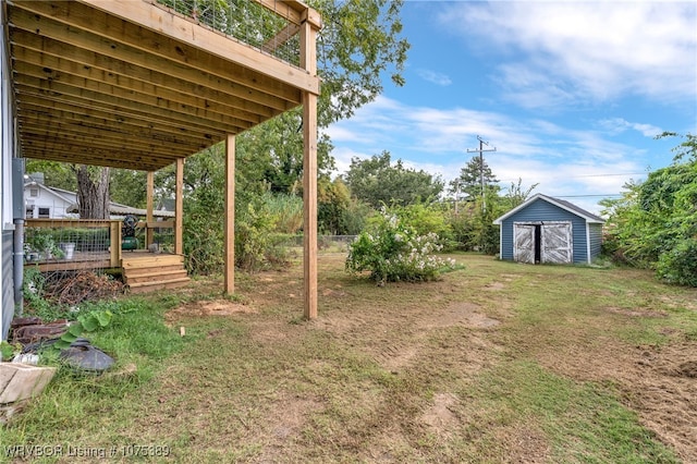 view of yard with a deck and a storage shed