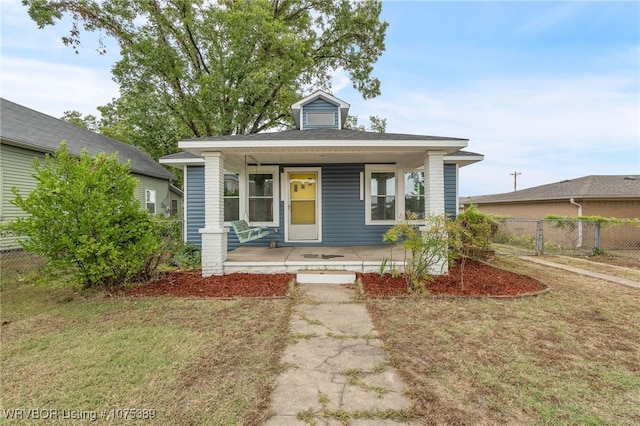 bungalow-style house featuring a porch and a front yard