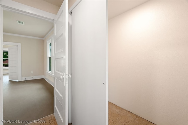 hallway with parquet flooring and crown molding